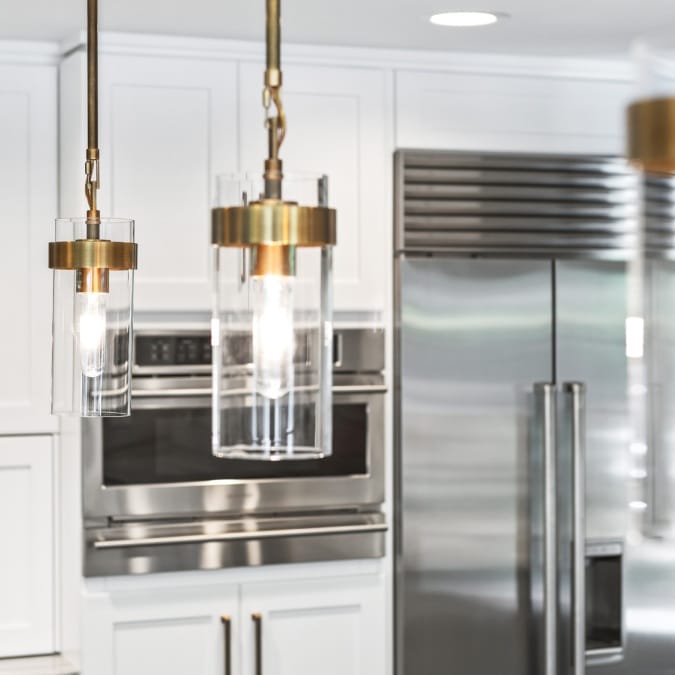 Gold Pedant Lighting Beside White Shakers