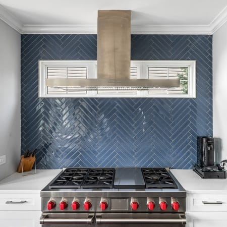 Custom Hood Against Blue Backsplash