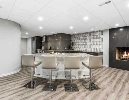 Modern Basement Featuring Luxury Vinyl Tile and a Fireplace