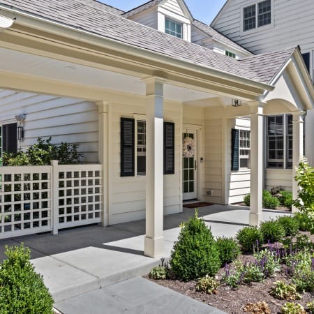 Covered Walkway with Recessed Lighting and White Pillars