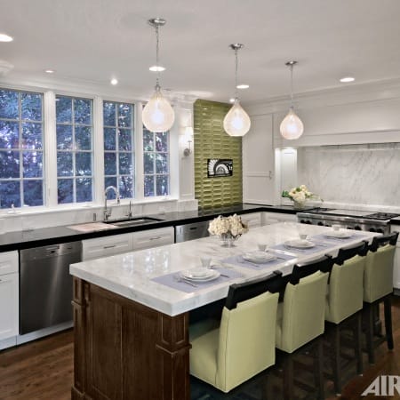 Sage Green Tile Backsplash with Perimeter Black Granite Countertops