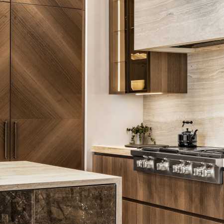 Neolith stone fume hood, countertops and waterfall island edge with professional range top and panel front refrigerator