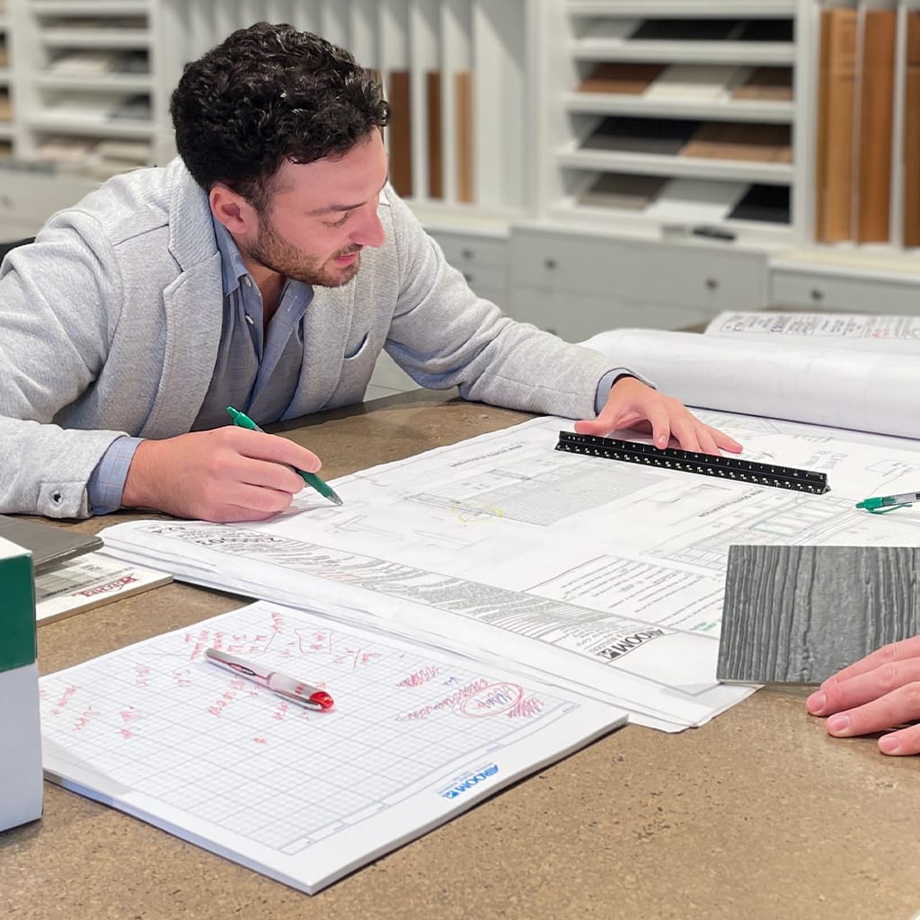 Image of man reviewing measurements on a blueprint