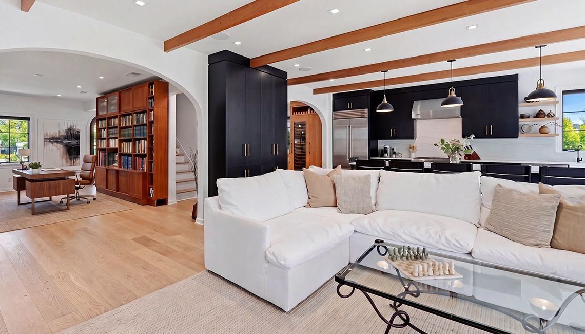 Interior living room remodel with large, wooden ceiling beams.
