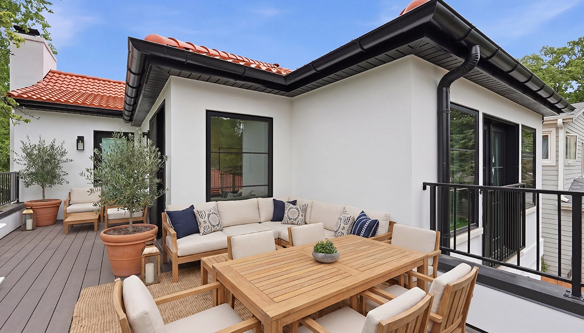 Second story outdoor patio with seating for a group.
