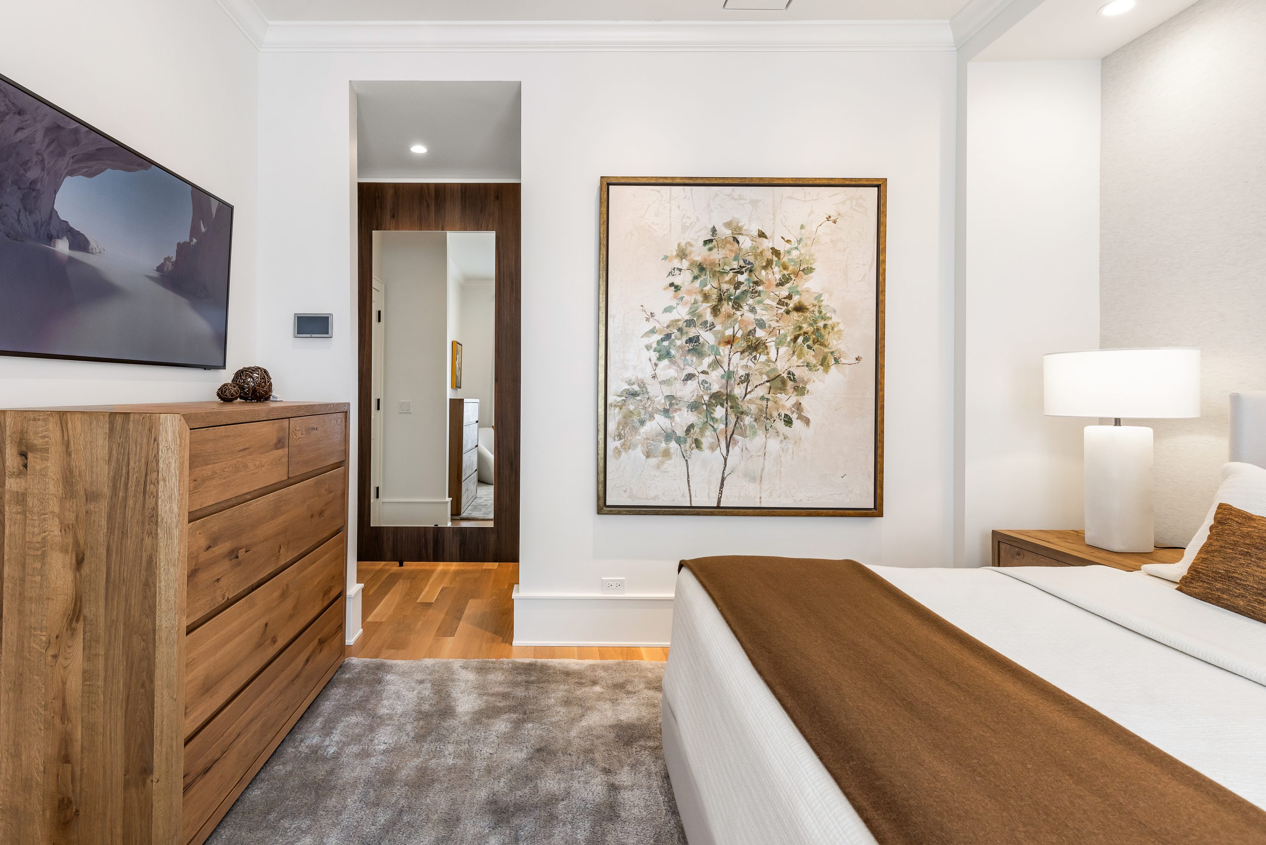 Remodeled primary suite with a king-sized bed, walk-in closet, and on-suite bathroom.